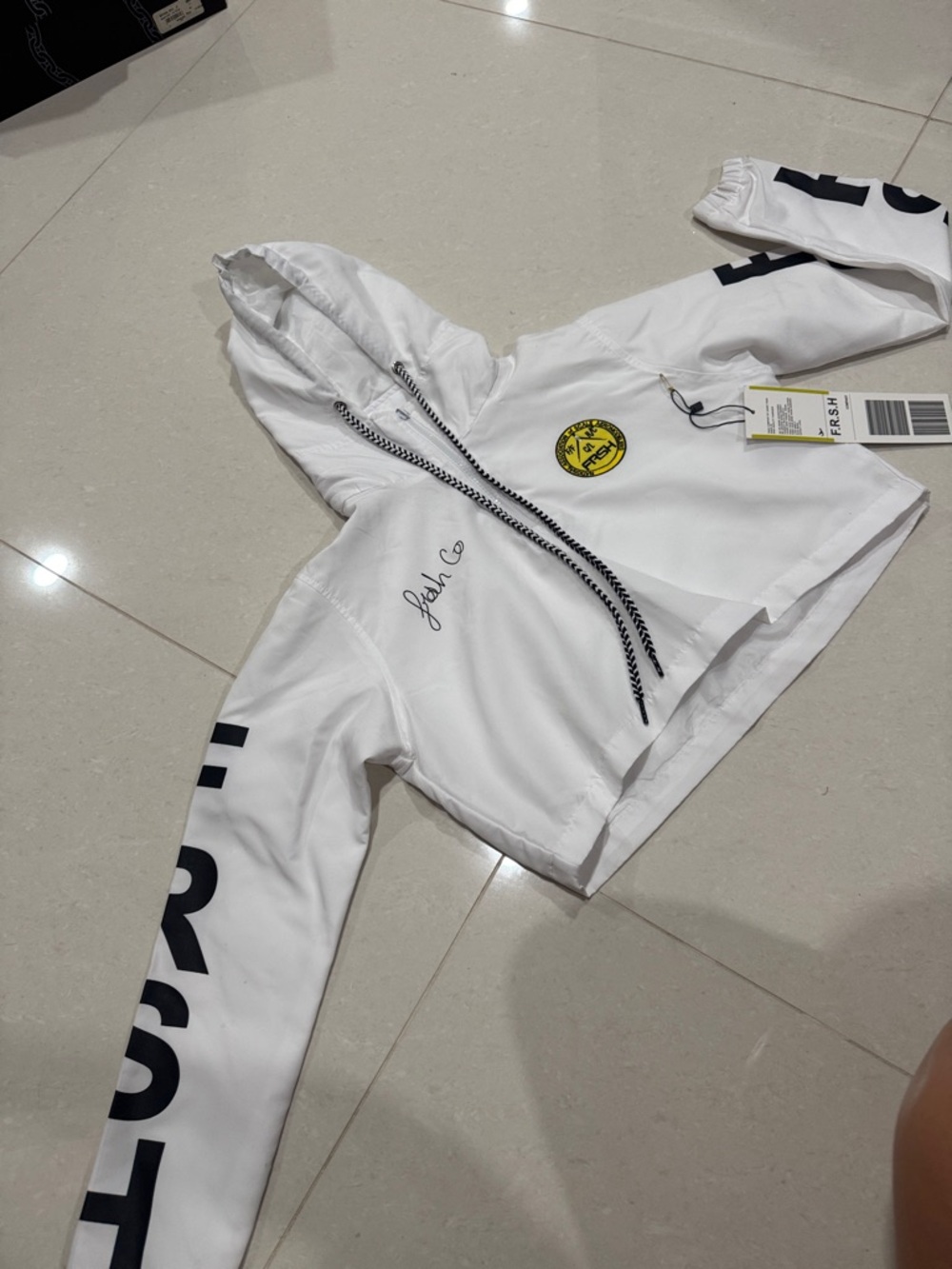 White Graphic Hoodie with Black Drawstrings and Yellow Patch